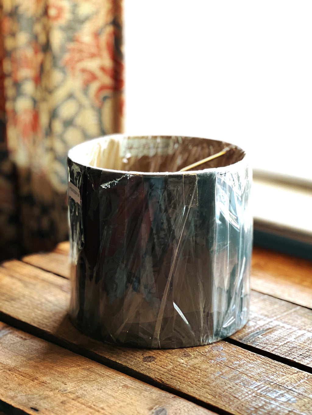 Decorative lampshade on a wooden surface with a blurred background