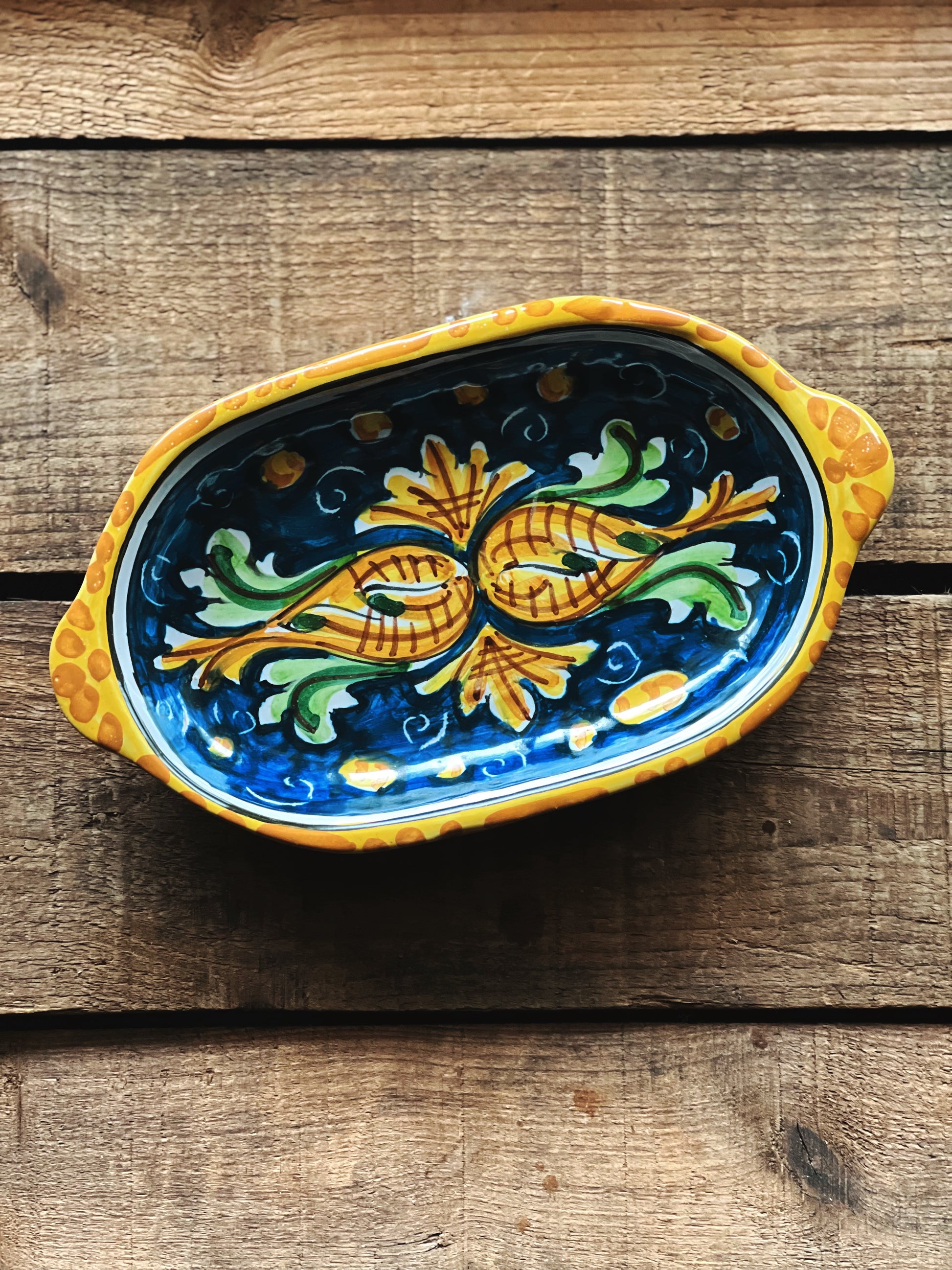 hand painted Italian platter on a wood surface