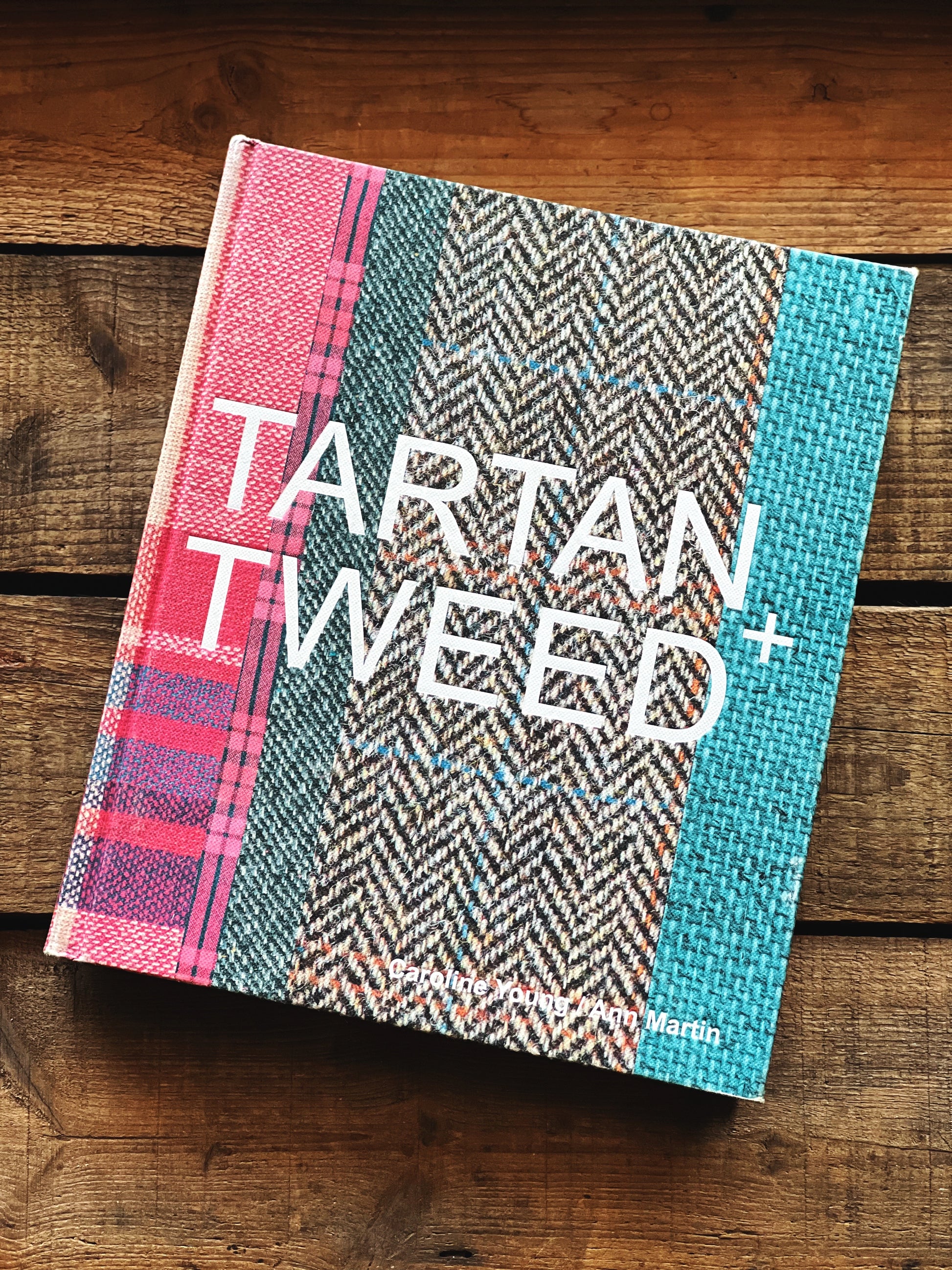 Book titled 'Tartan Tweed' on a wooden surface