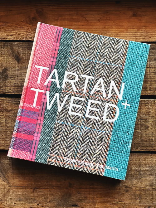 Book titled 'Tartan Tweed' on a wooden surface