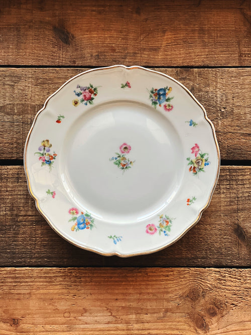 Decorative plate with floral patterns on a wooden surface