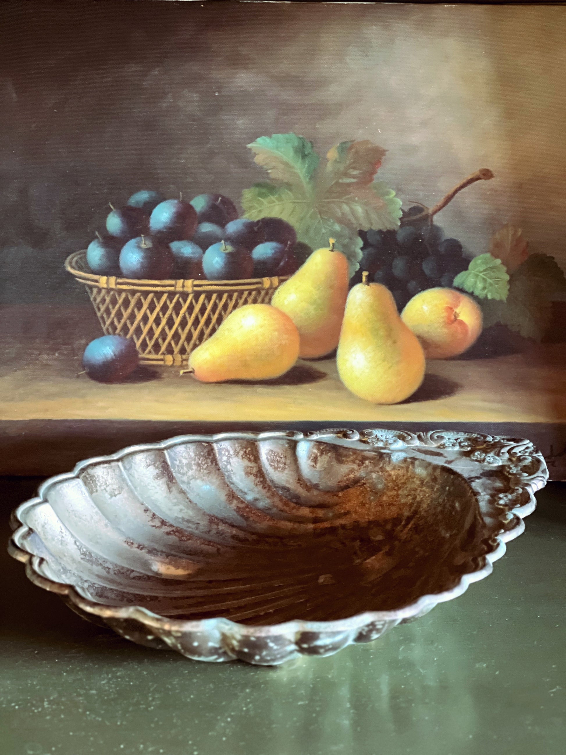 Still life painting of fruits including pears and plums on a table with a decorative shell dish.