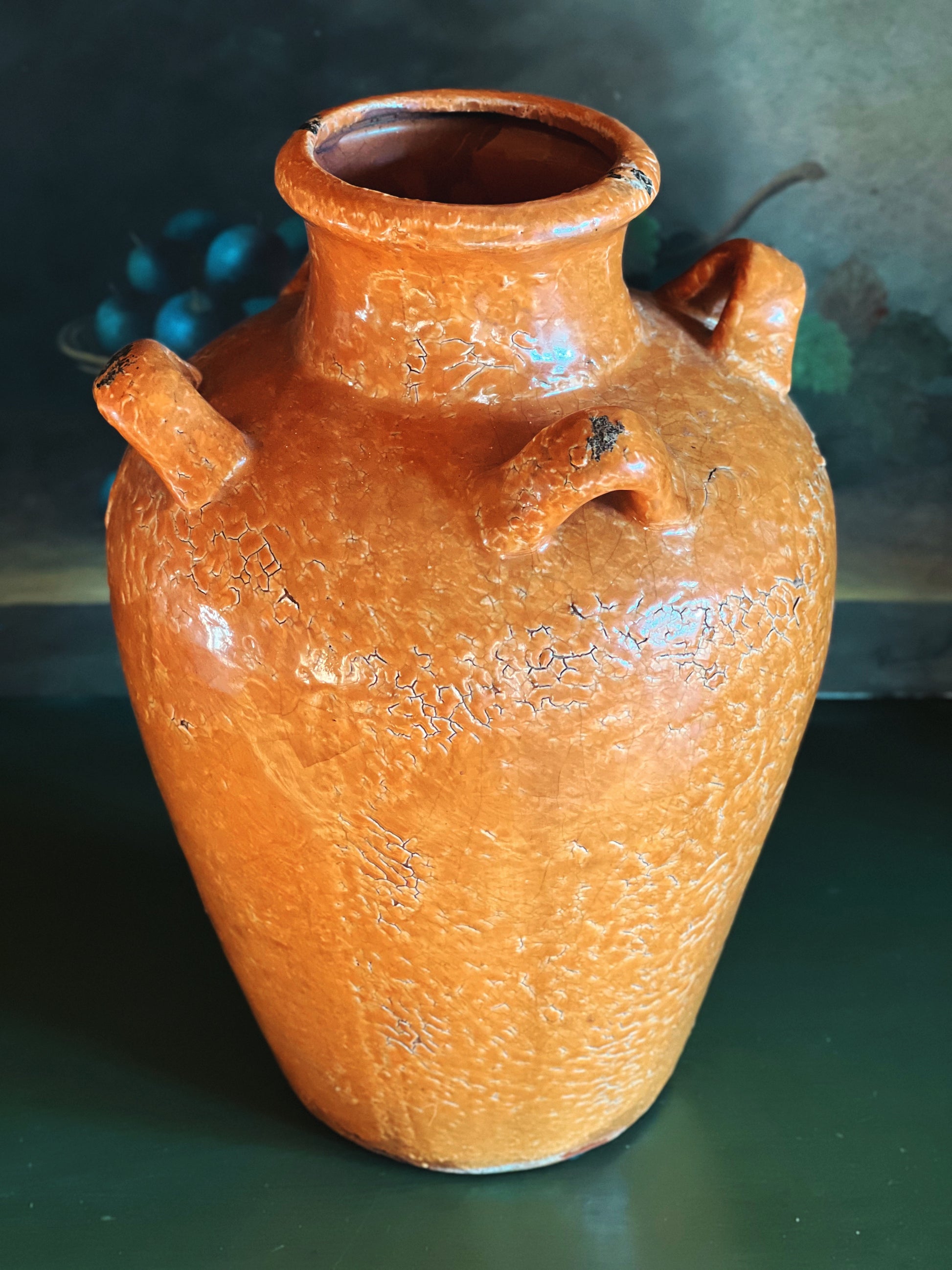 Terracotta jar with a textured surface on a dark background