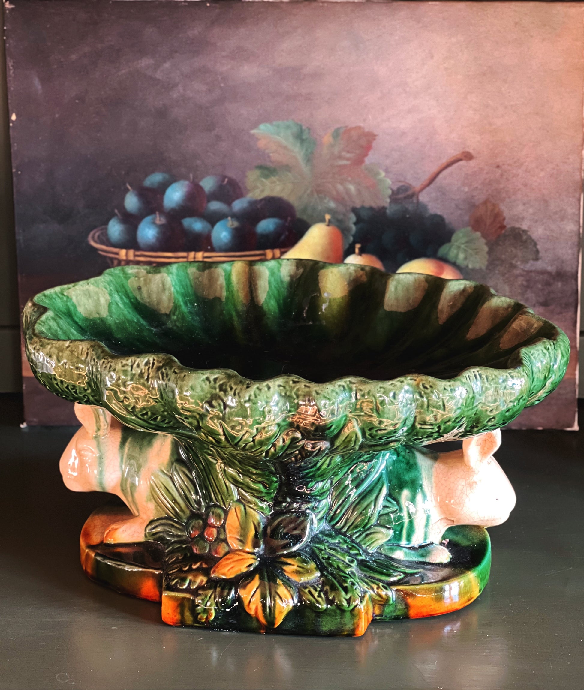 Decorative ceramic fruit bowl with fruit on a dark background