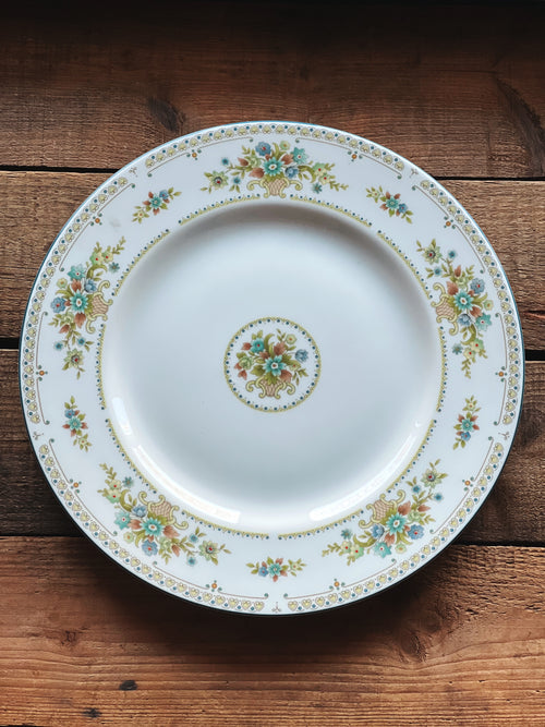 Decorative plate with floral patterns on a wooden surface