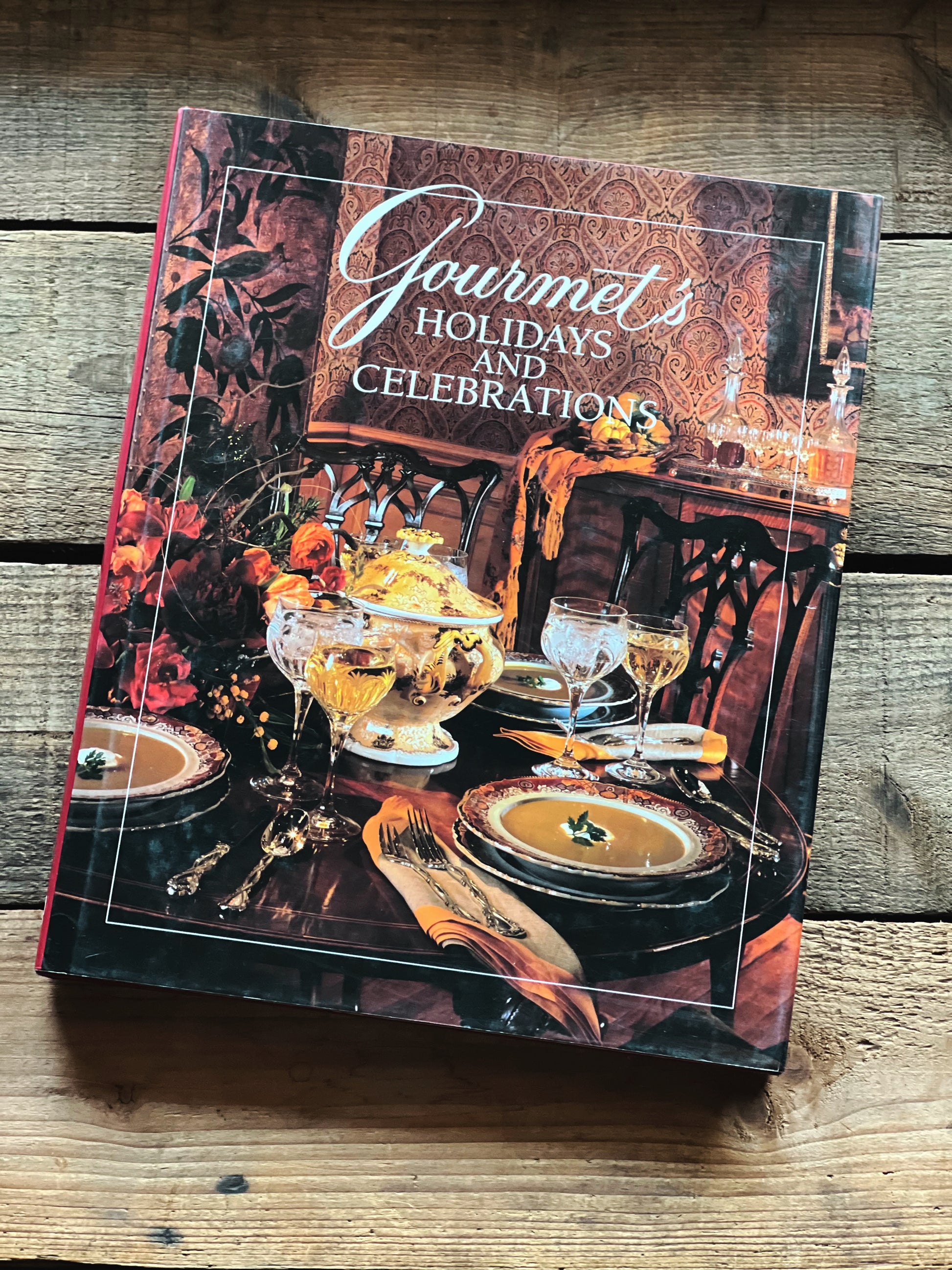 Cookbook titled 'Gourmet's Holidays and Celebrations' on a wooden surface