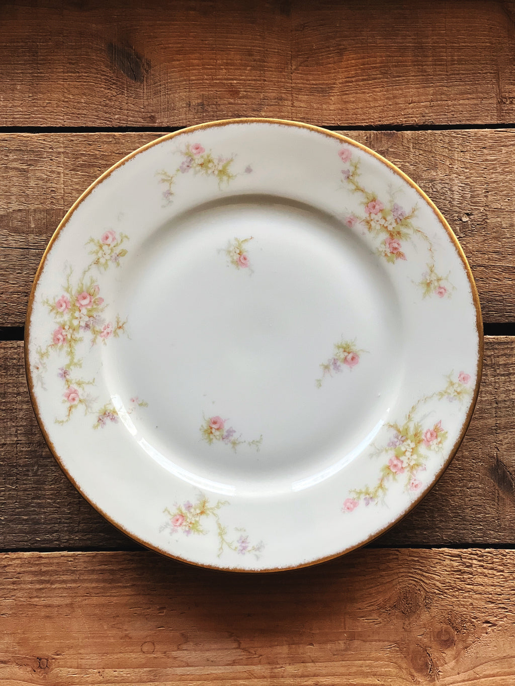 Decorative ceramic plate with floral patterns on a wooden surface