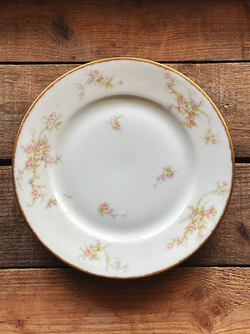 Decorative ceramic plate with floral patterns on a wooden surface