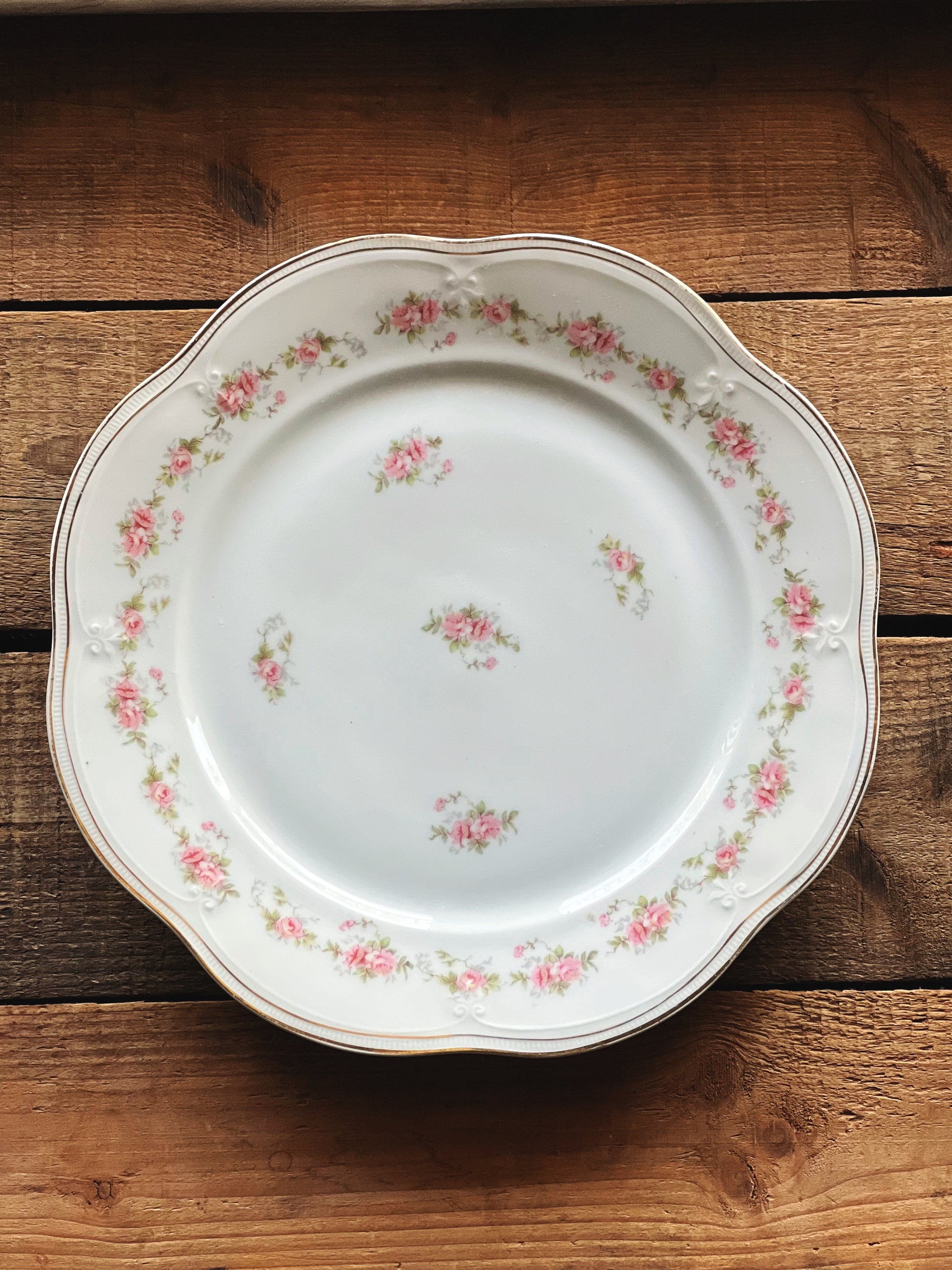 Decorative plate with floral pattern on a wooden surface