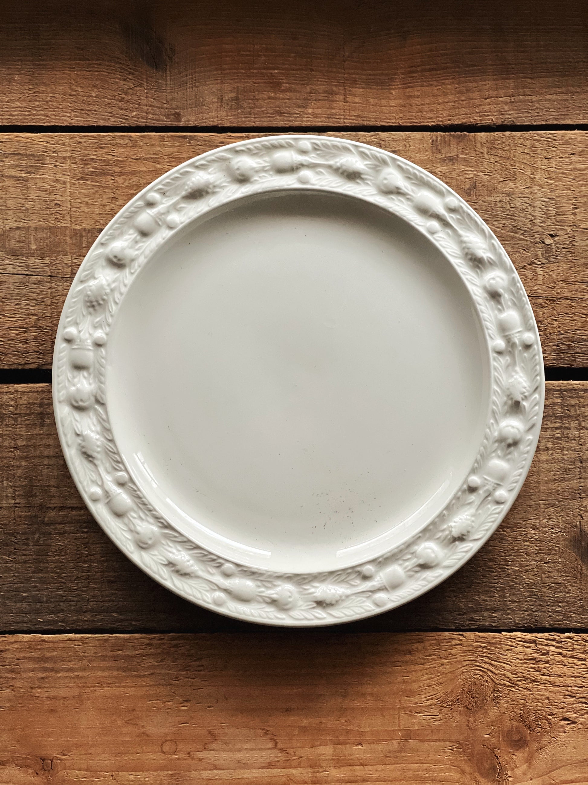 White decorative plate on a wooden surface