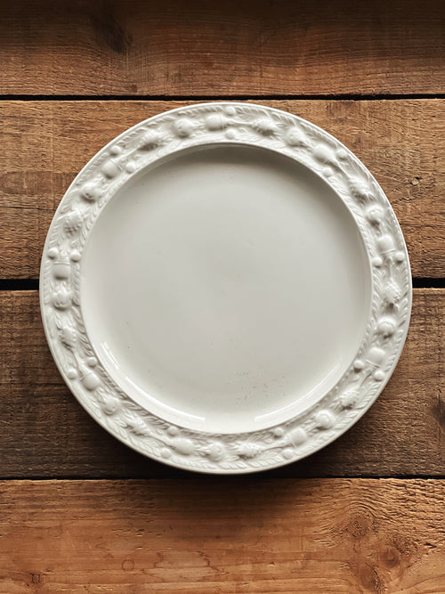 White decorative plate on a wooden surface