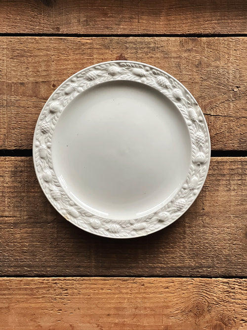 White decorative plate on a wooden surface