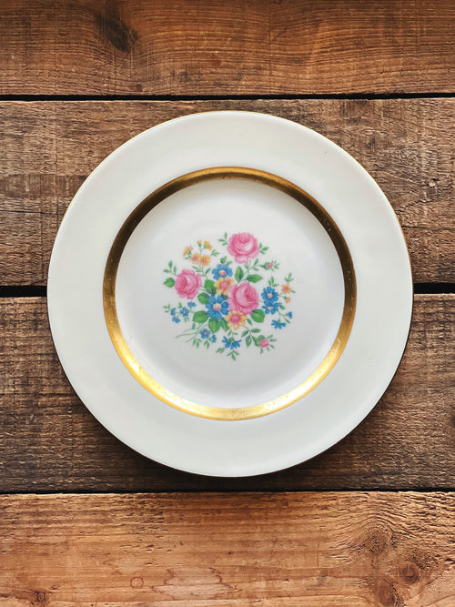 Decorative plate with floral design on a wooden surface
