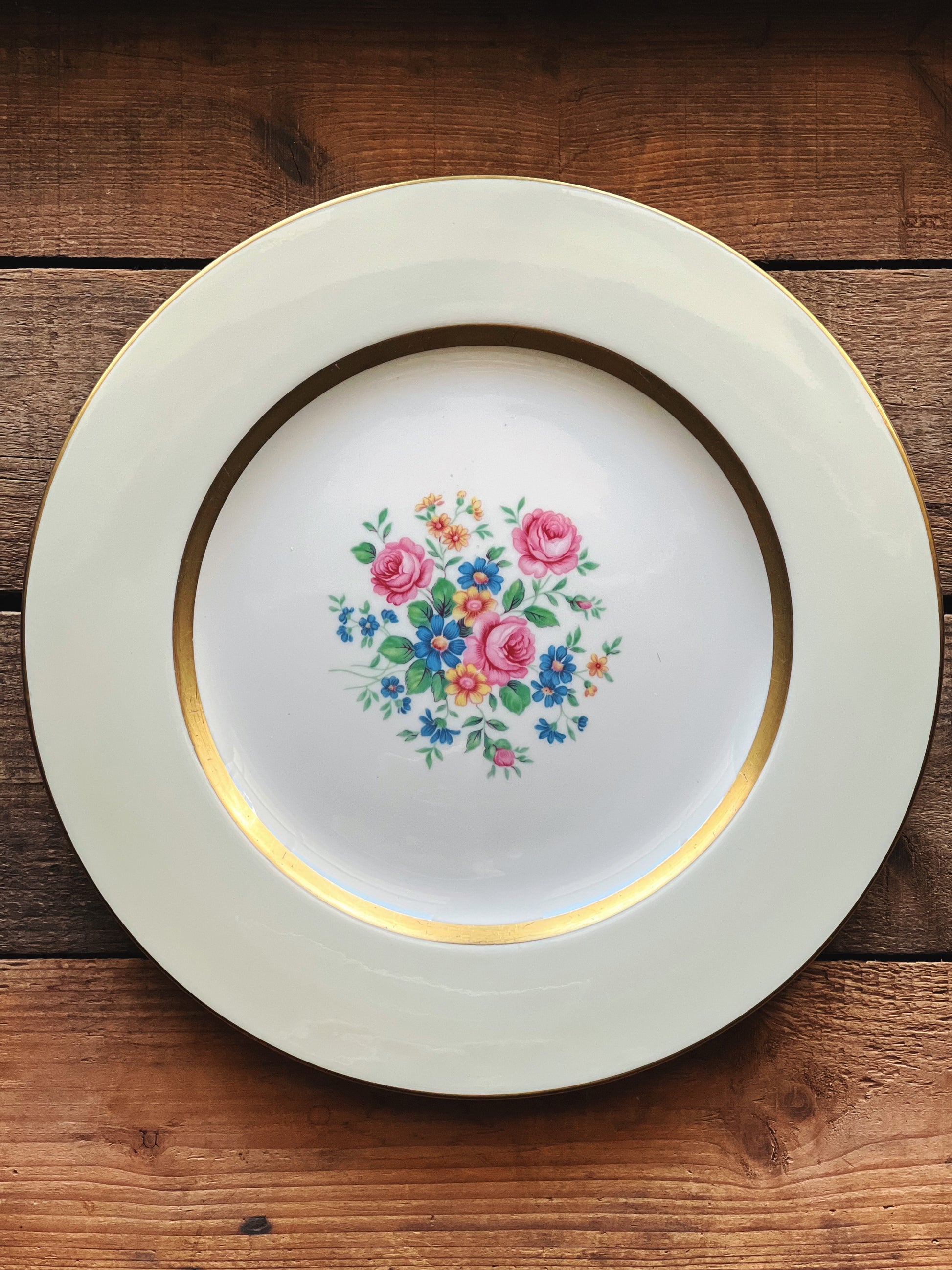 Decorative plate with floral design on a wooden surface