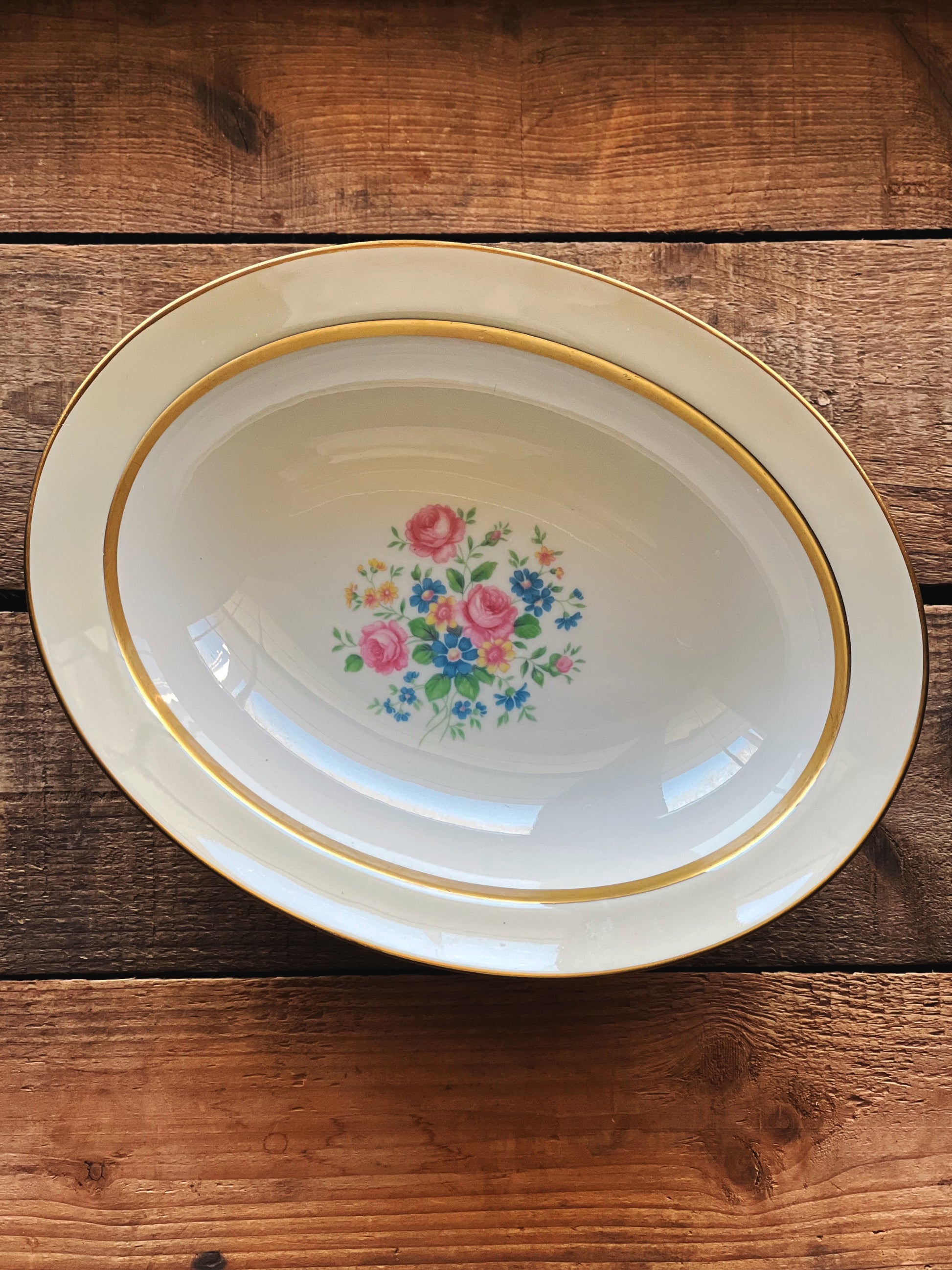 Decorative plate with floral design on a wooden surface