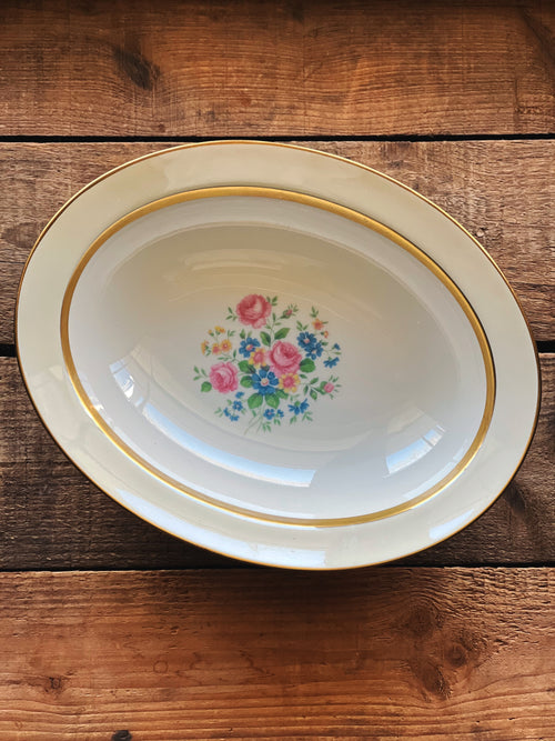 Decorative plate with floral design on a wooden surface