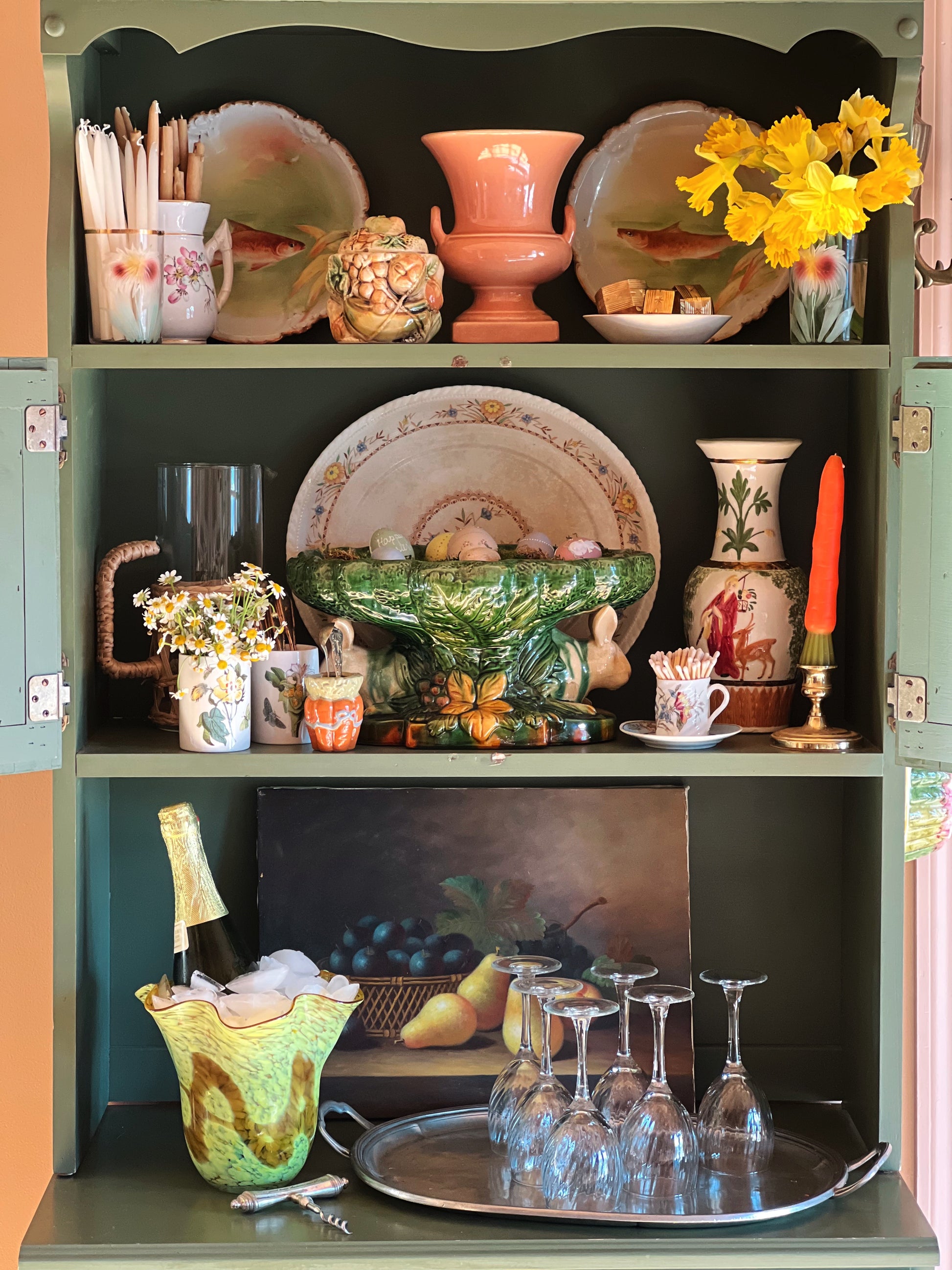 Decorative shelf with various items including plates, vases, and glasses.