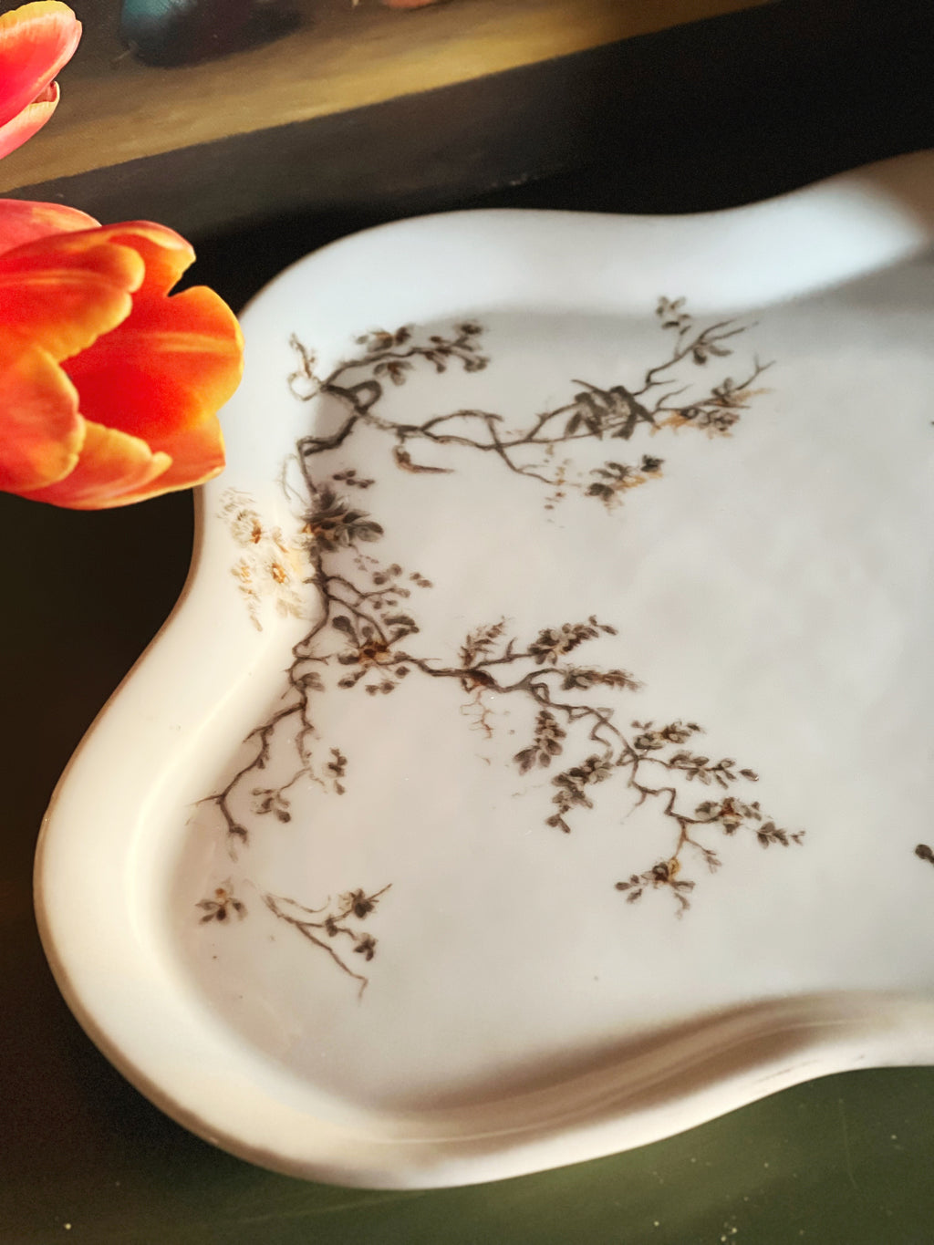 Close view of antique floral transferware tray with delicate floral motif and scalloped edges