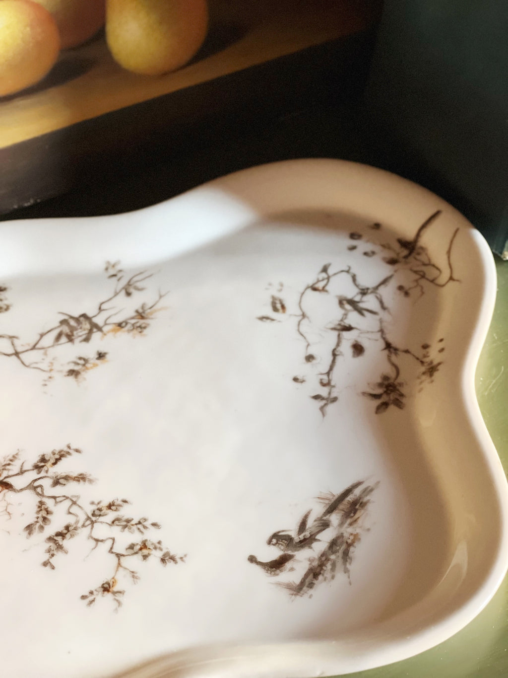 Close view of antique floral transferware tray with delicate floral motif and curved edges