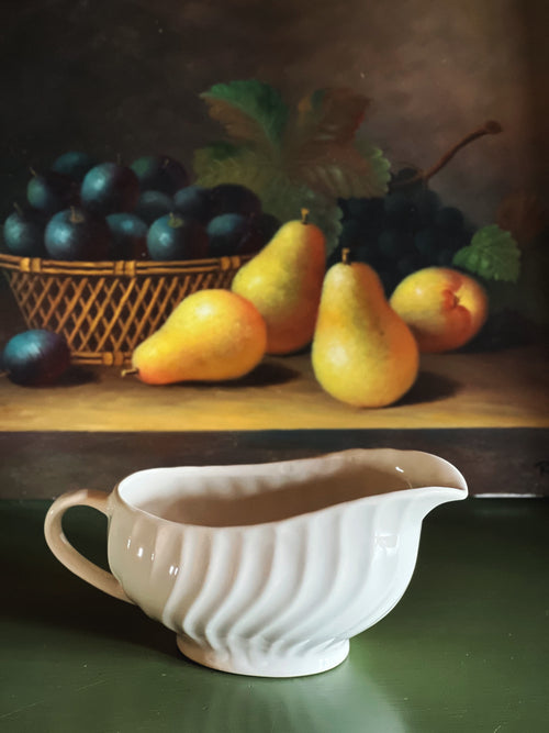 Vintage Johnson Brothers Regency gravy boat styled on a warm wood table with pears and moody still life styling