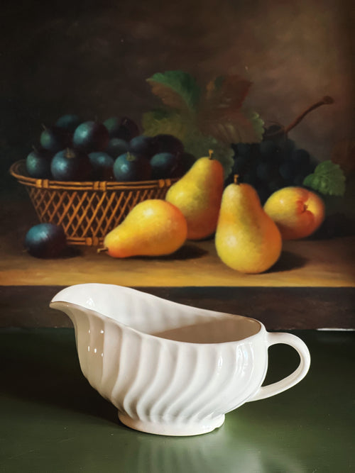 Side profile of vintage Johnson Brothers Regency ironstone gravy boat with embossed swirl detail