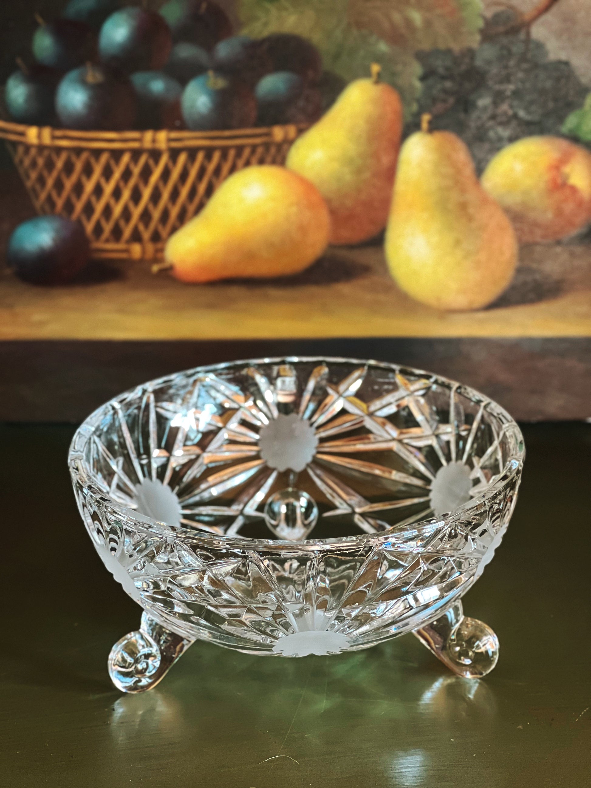 Decorative crystal bowl with fruits in the background