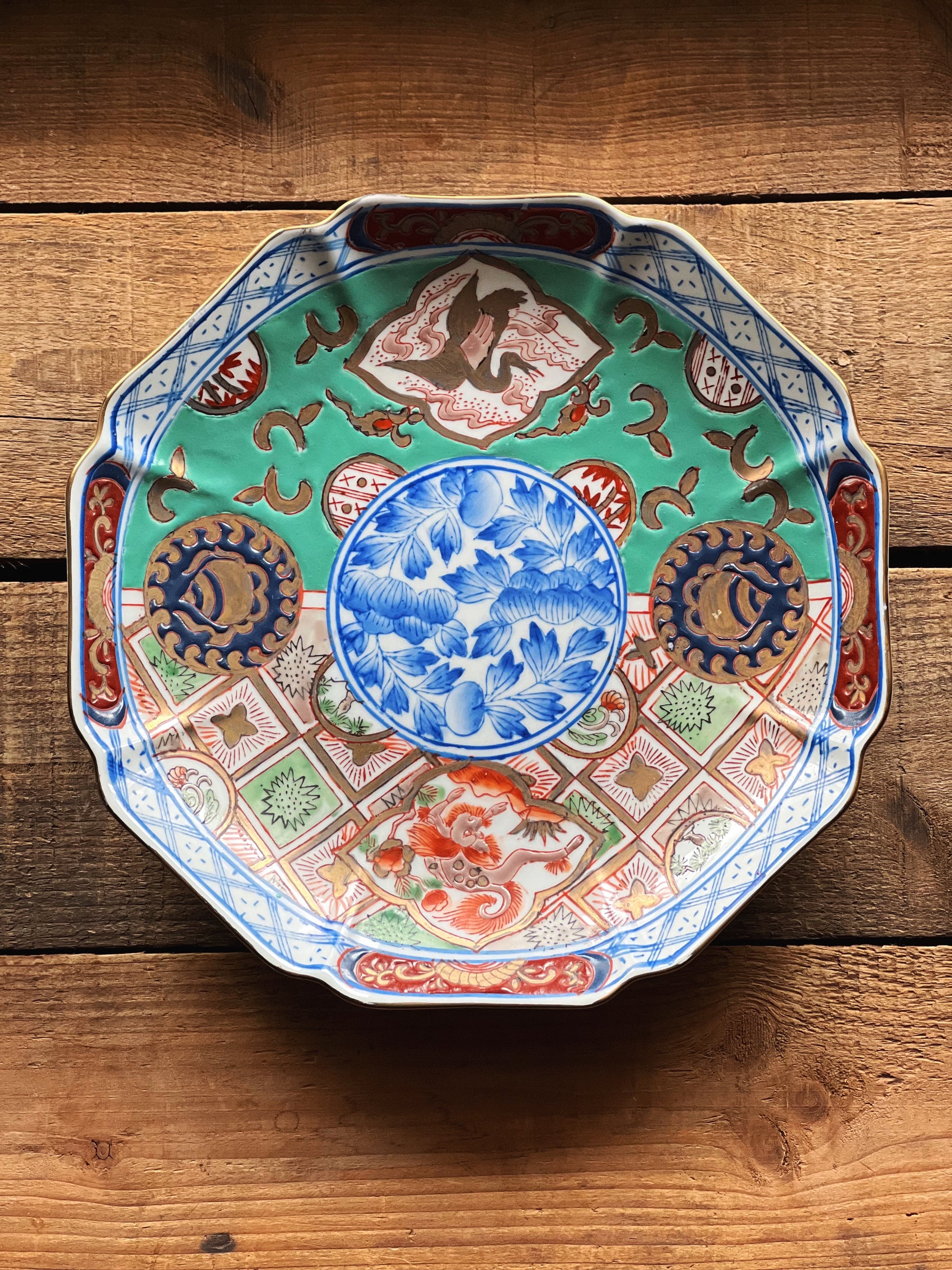 Decorative ceramic plate with intricate patterns on a wooden surface