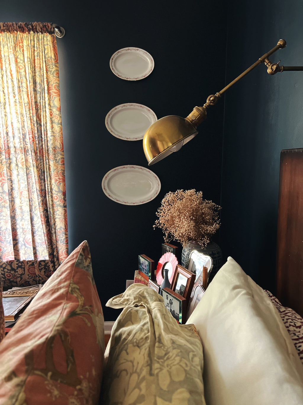 Small vintage plate wall with antique Limoges serving platter styled in a cozy interior
