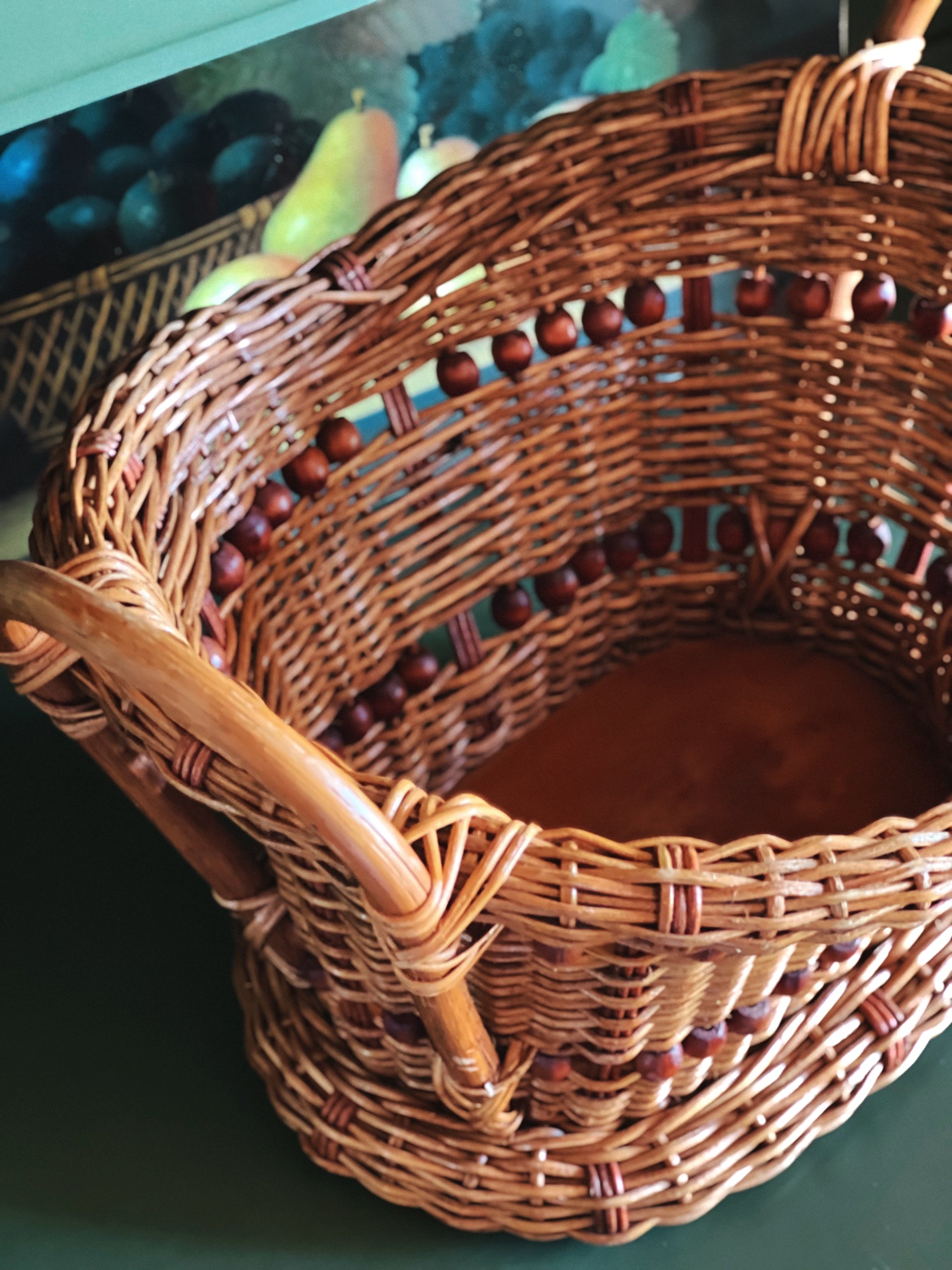 Woven bamboo basket with decorative bead trim, oval storage basket