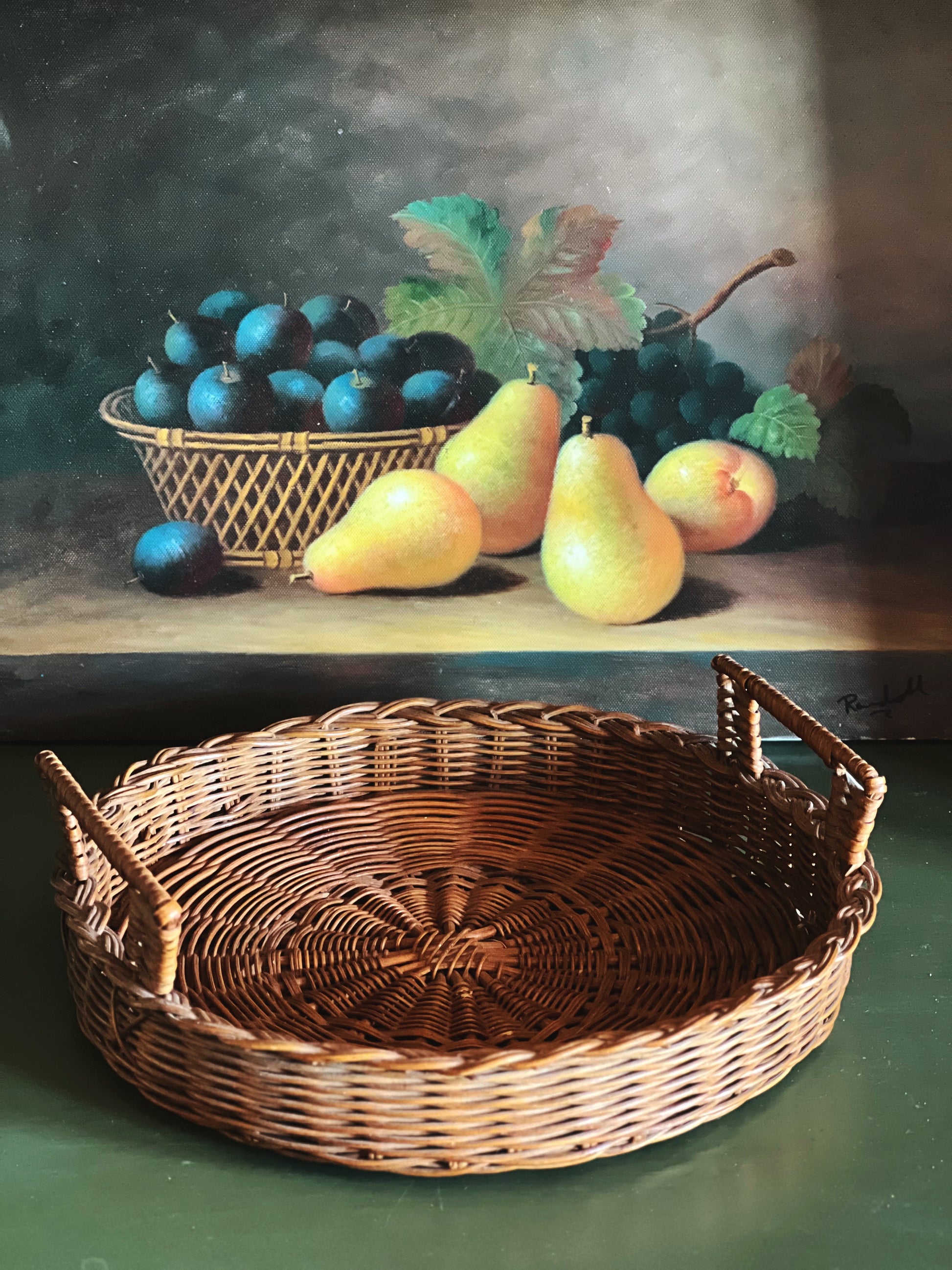 Light wicker serving tray styled with fruit, vintage tabletop decor