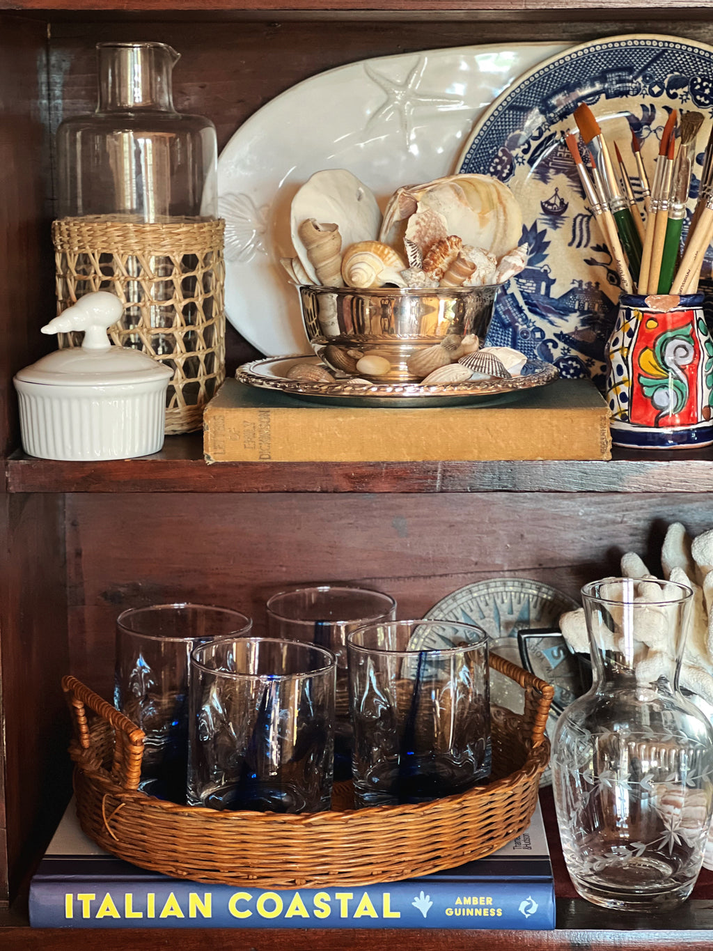 Vintage wicker tray on shelf, layered home decor styling