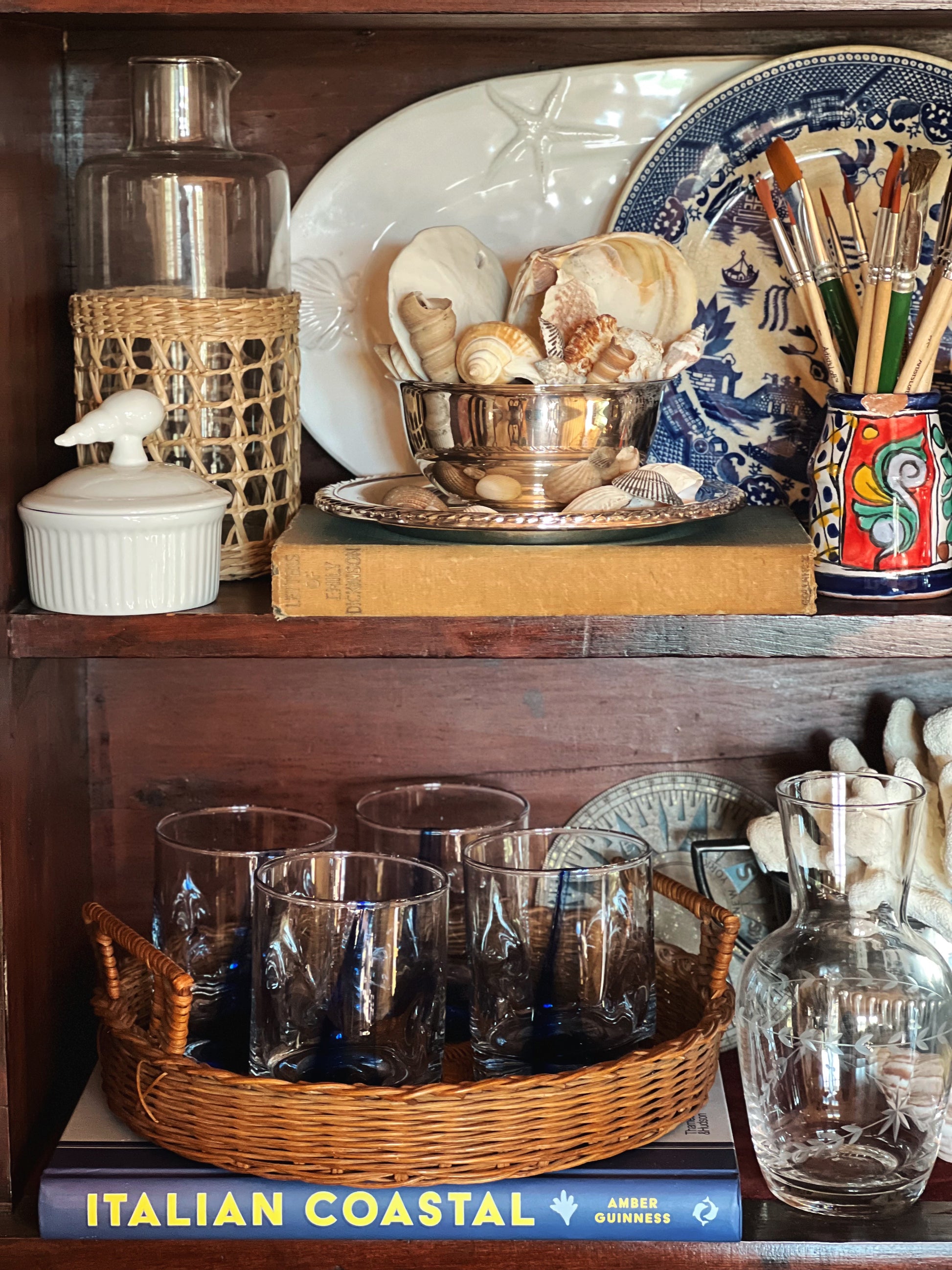 Vintage wicker tray on shelf, layered home decor styling