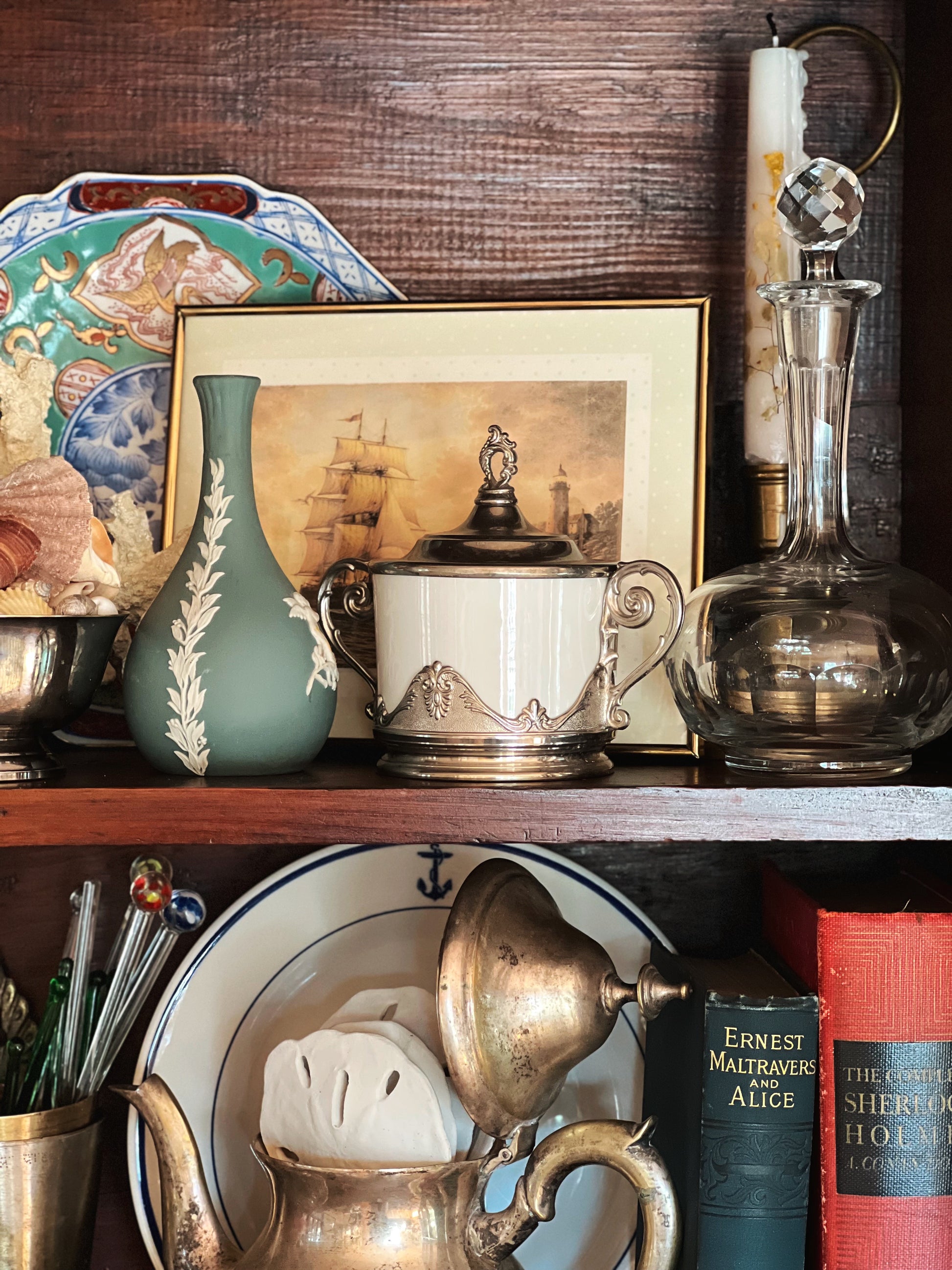 vintage glass decanter styled on a shelf with coastal decor