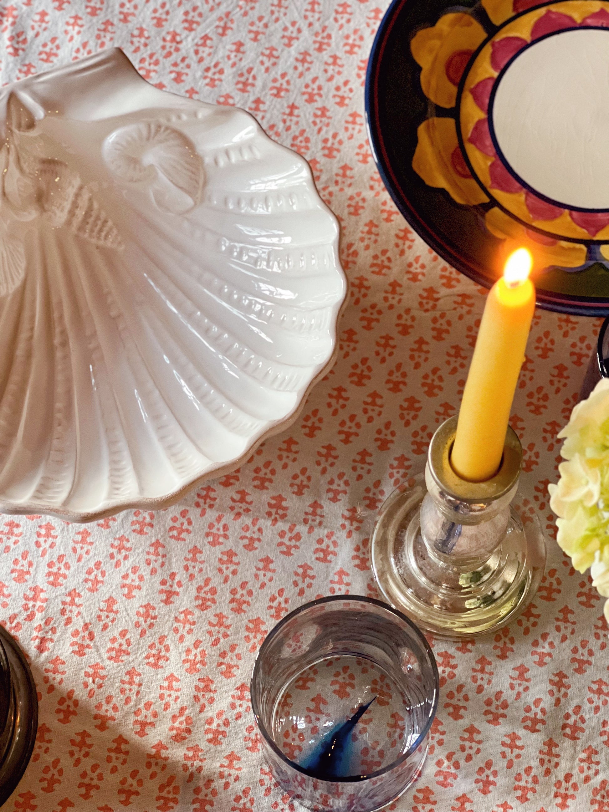 Close-up of embossed ceramic shell design on white serving dish