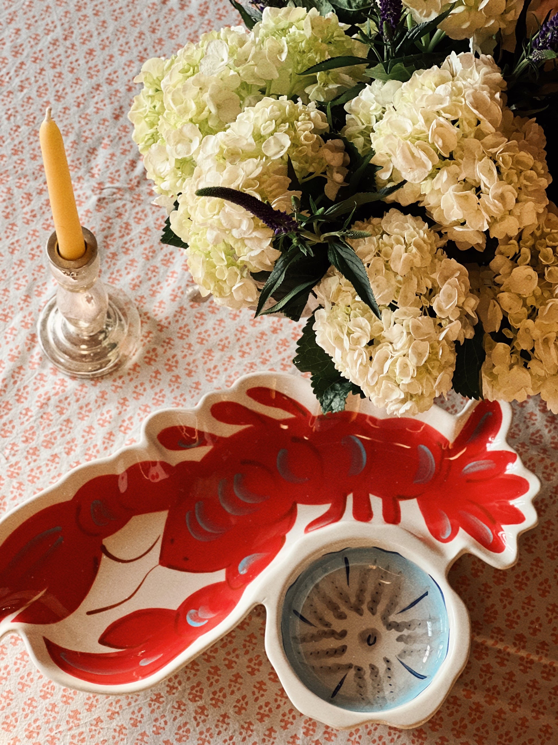 Overhead view of lobster-shaped ceramic serving platter with integrated dip bowl