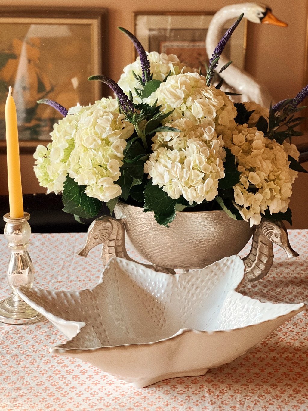 Coastal-inspired ceramic starfish serving bowl styled alongside vintage tableware and florals