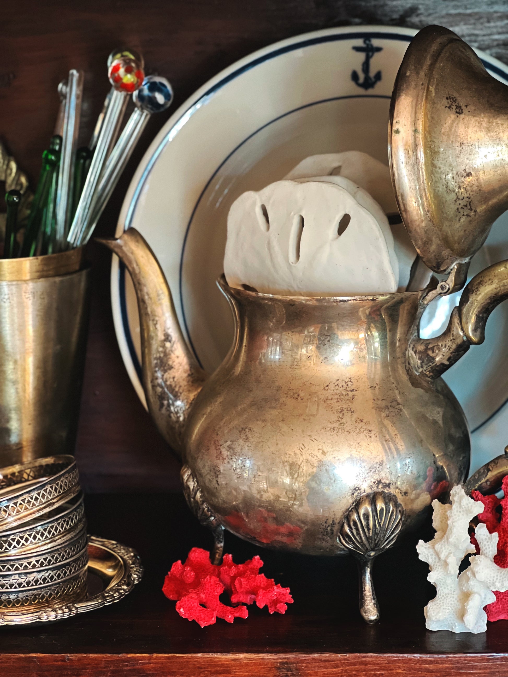 Side view of vintage silver plate coffee pot with curved spout