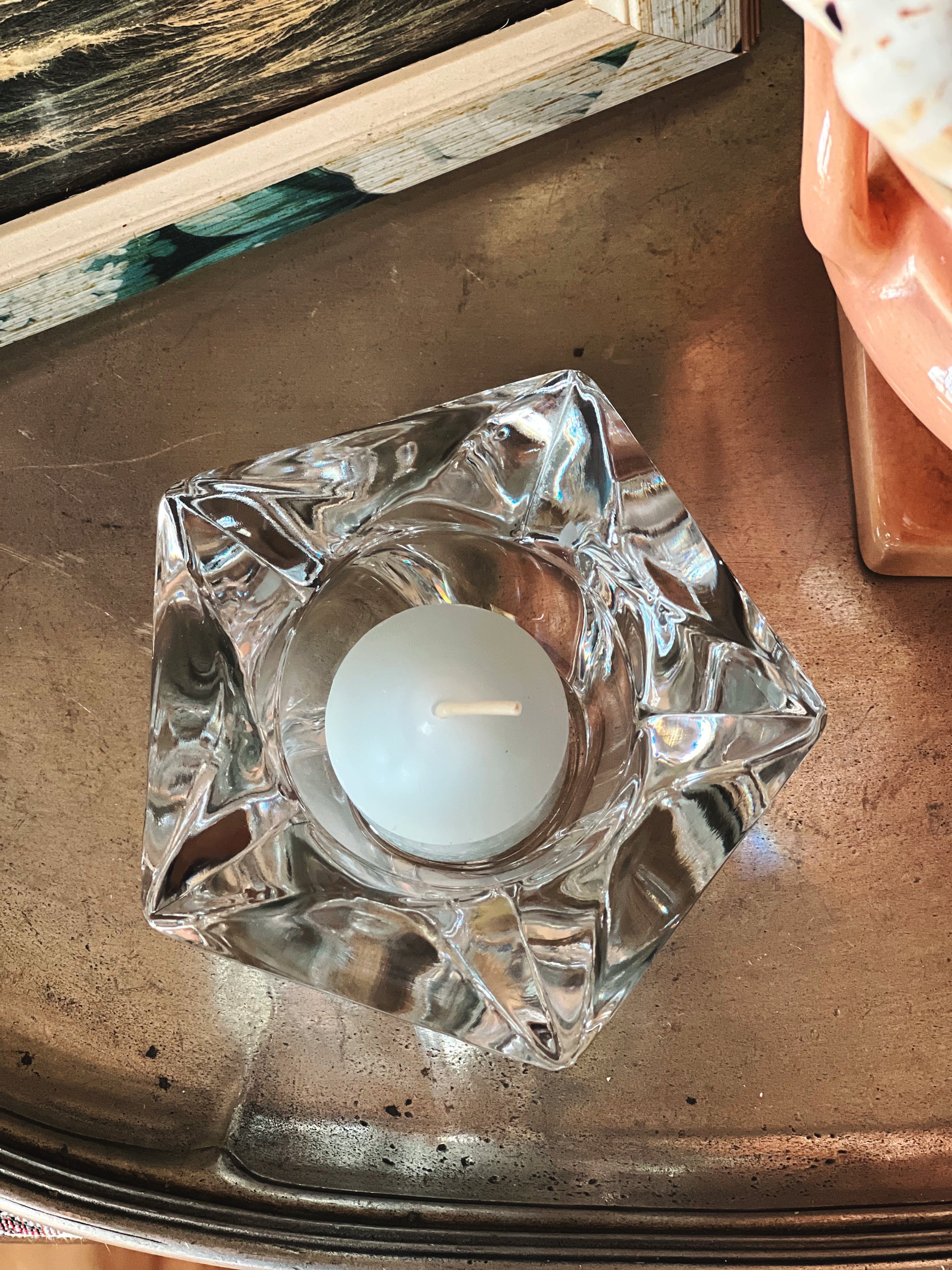 Clear cut glass starfish votive holder with faceted edges and tealight candle