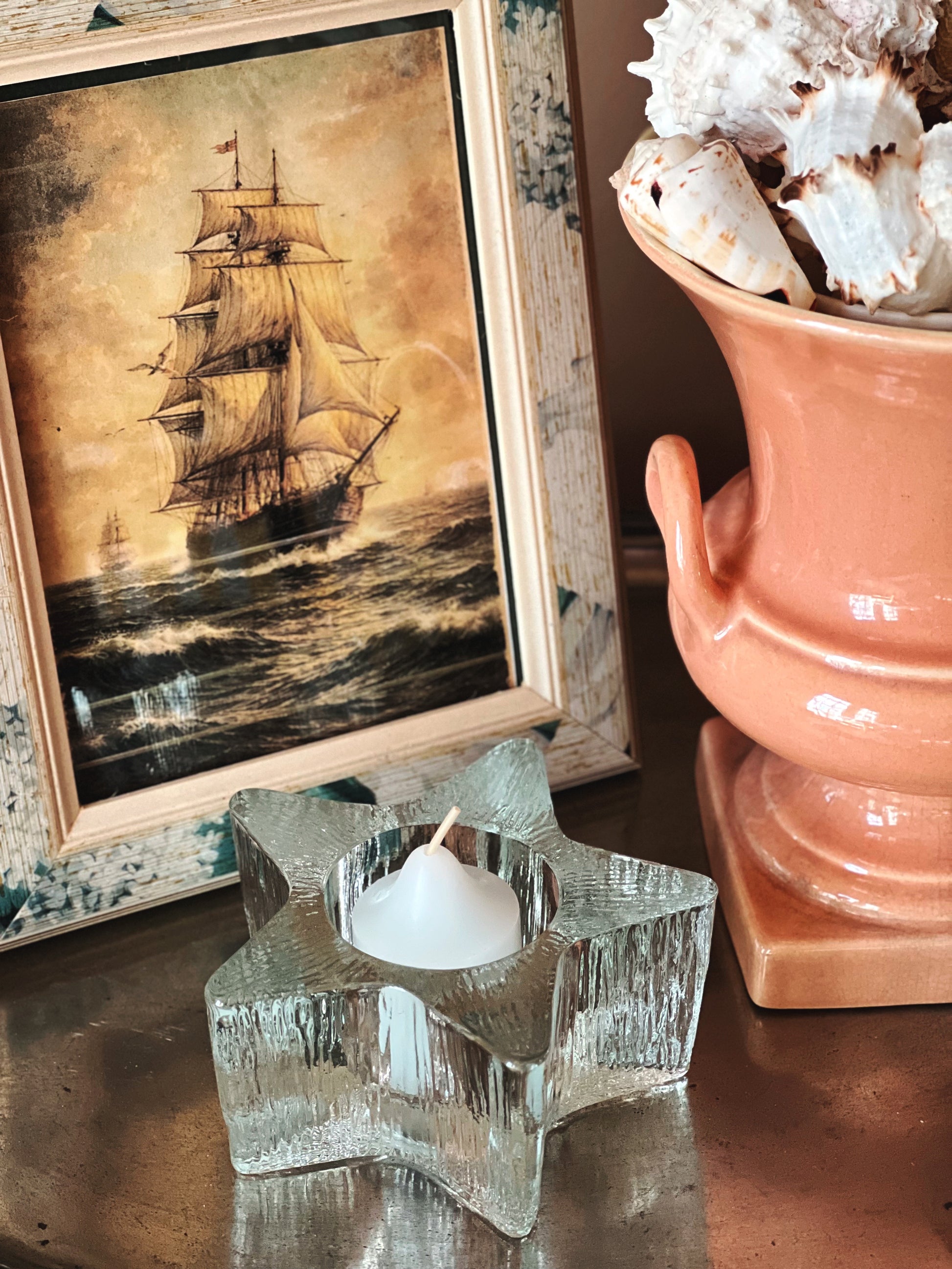 Clear vintage Avon glass votive holder with ribbed starfish shape and tealight candle