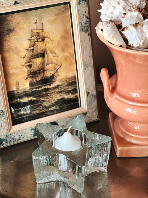 Clear vintage Avon glass votive holder with ribbed starfish shape and tealight candle