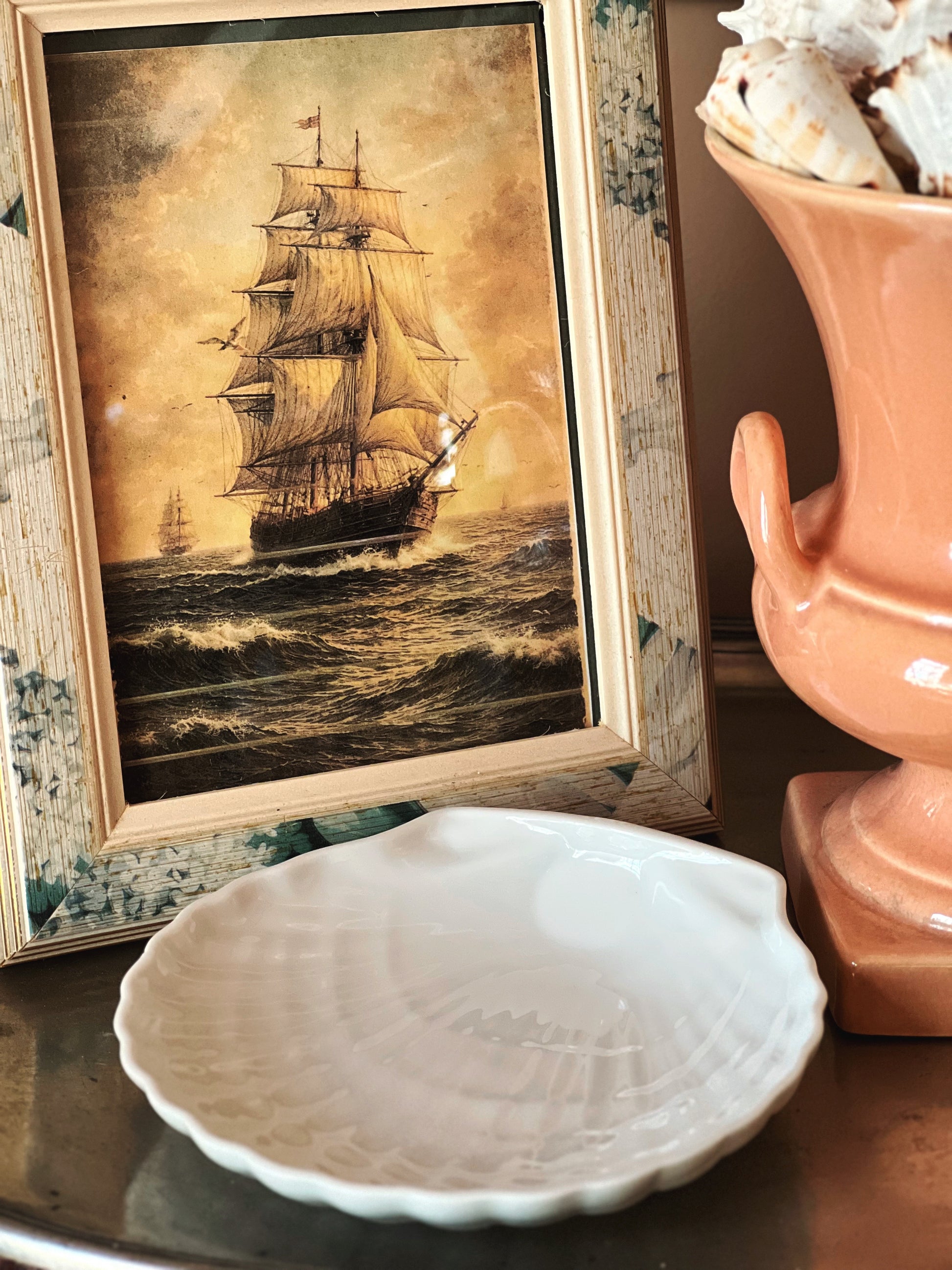 Coastal decor vignette with scallop shell dish, nautical styling