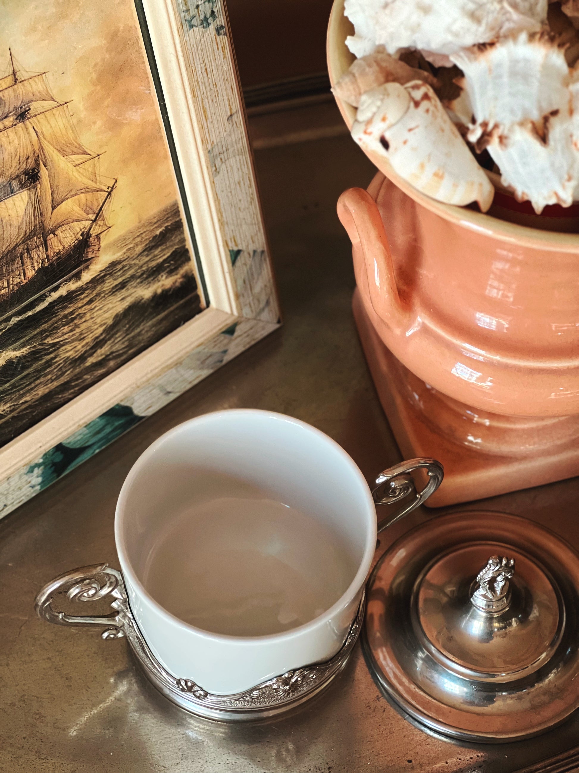 White ceramic ramekin with lid removed and silver holder detail