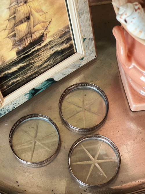 Set of vintage sterling silver and glass coasters with starburst pattern