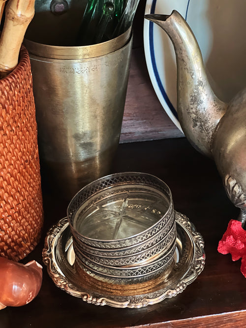Single vintage sterling and glass coaster close-up