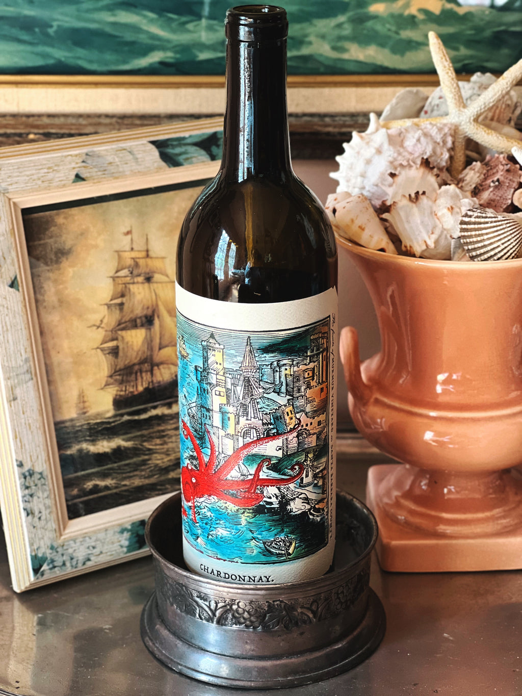 Vintage silver wine coaster holding a wine bottle styled on a bar with decorative accents