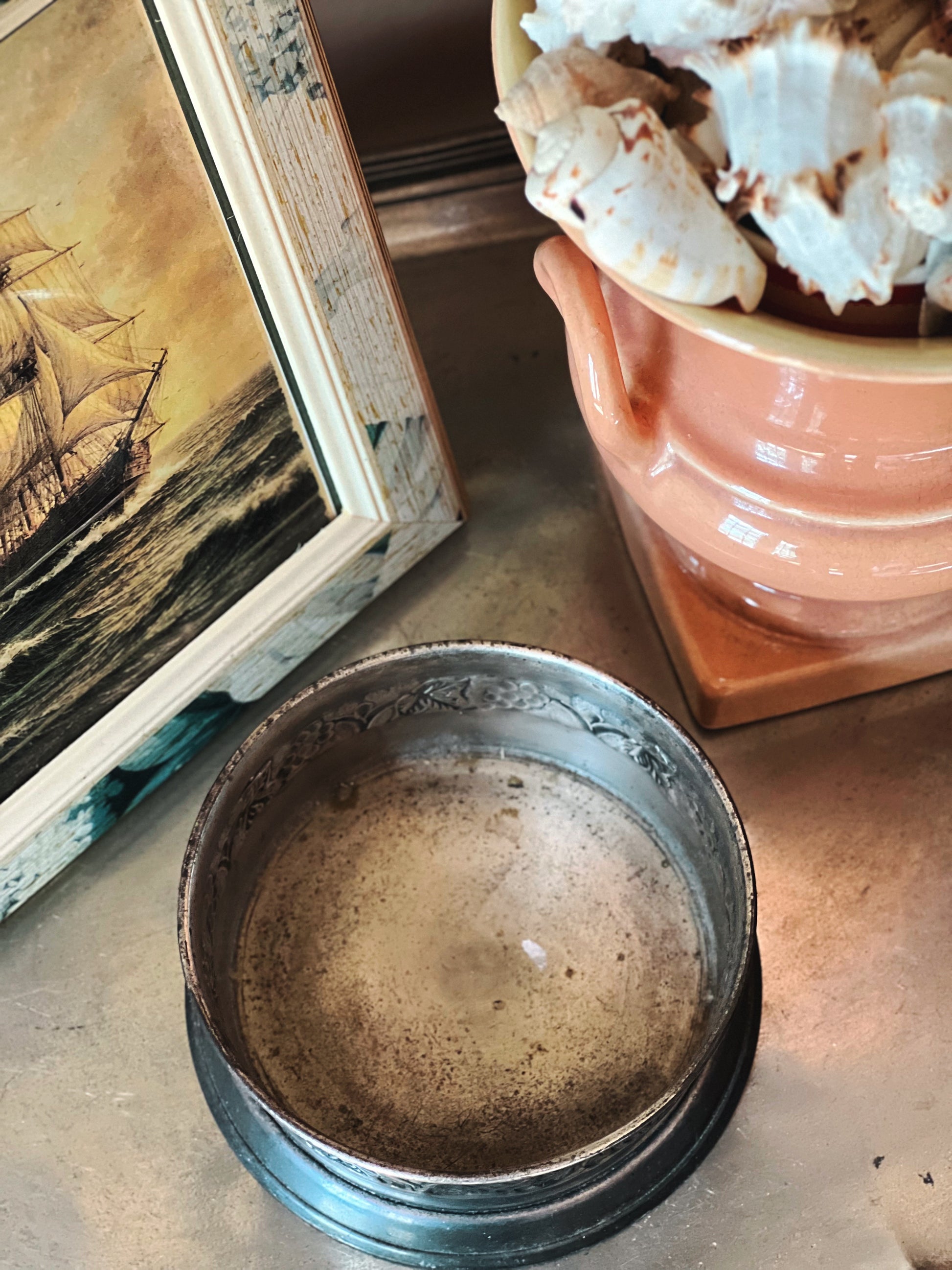 Interior of vintage silver wine coaster showing aged patina and wear