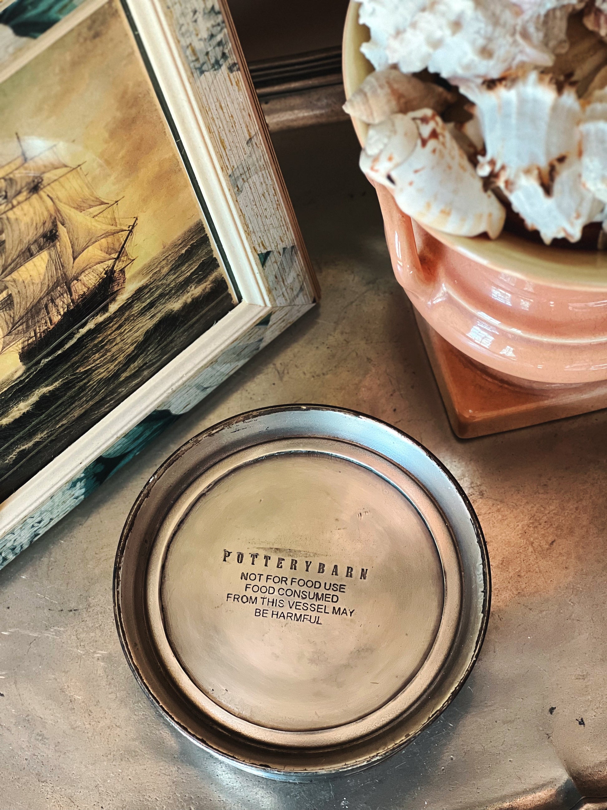 Underside of silver wine coaster showing base and condition