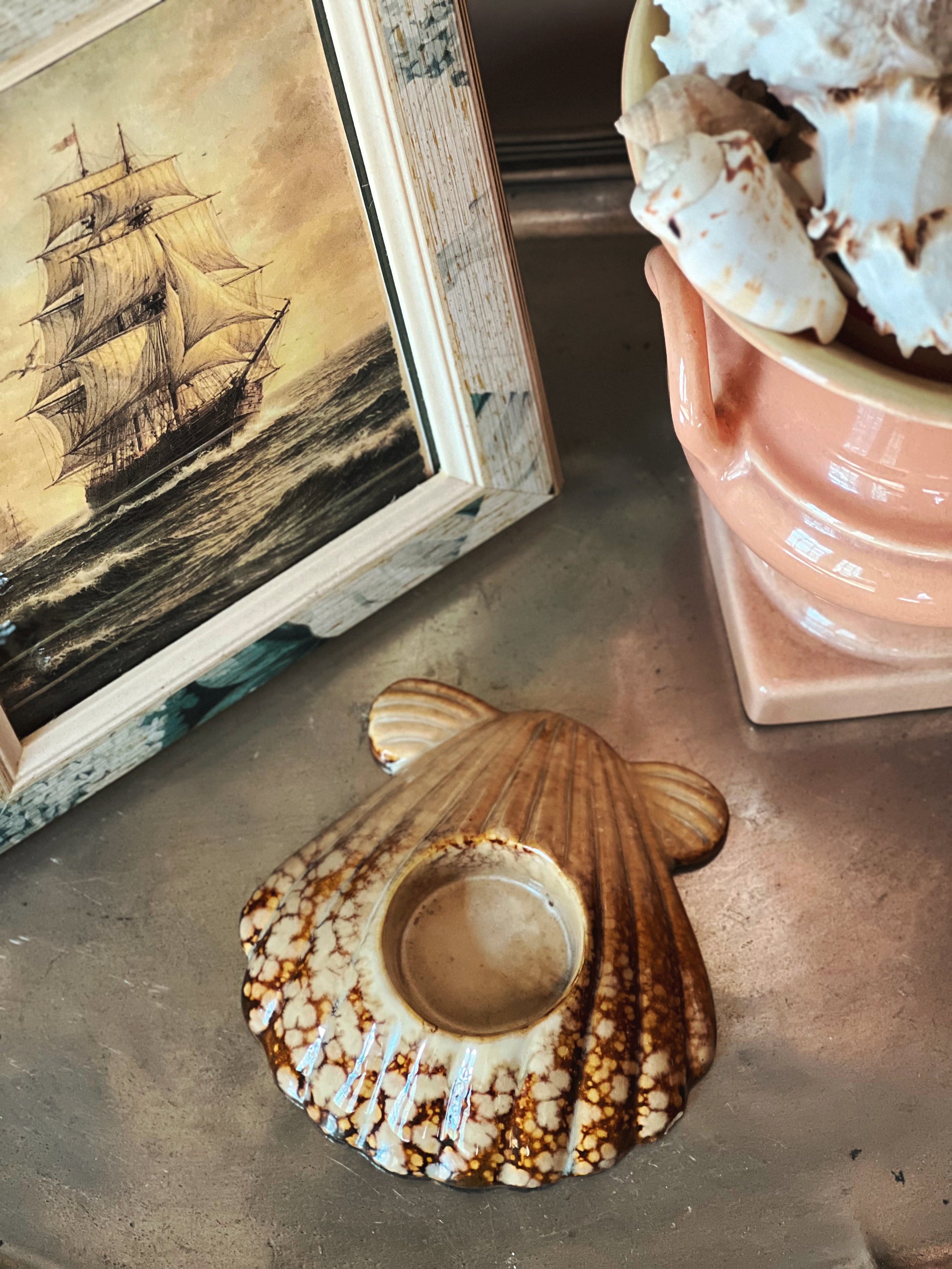 Vintage scallop shell candle holder showing textured ceramic detail and natural finish
