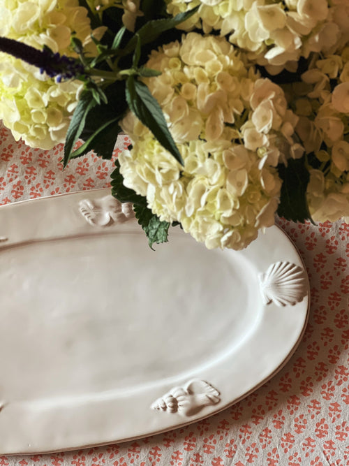 White oval serving platter with raised shell detail