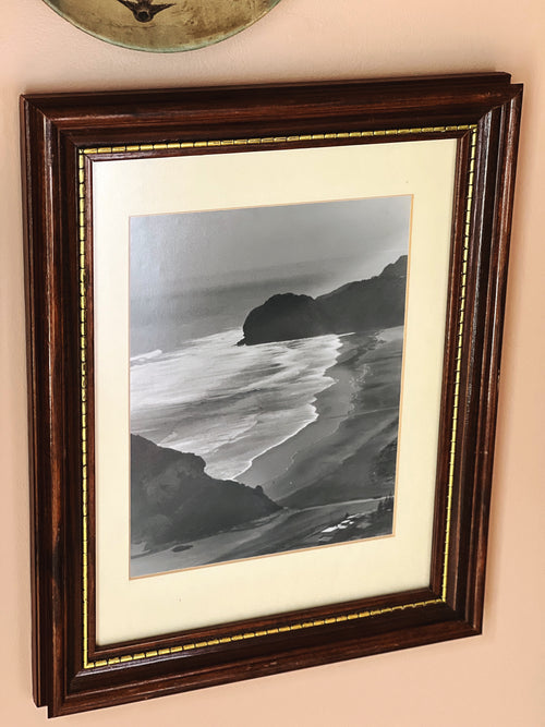 side view of vintage wood frame black and white coastal photograph
